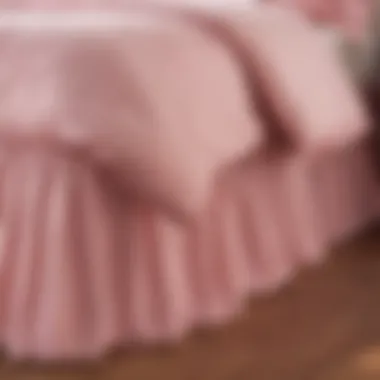 Different styles of pink bed skirts showcased in a display